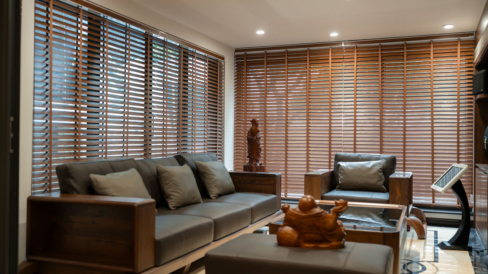 Living room with floor-to-ceiling wood blinds on every window